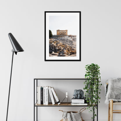 Mockup of wall art showing a big black wooden frame that is hanging on the wall of a living room and contains a photo of the Parthenon on the hill of Acropolis in Athens Greece